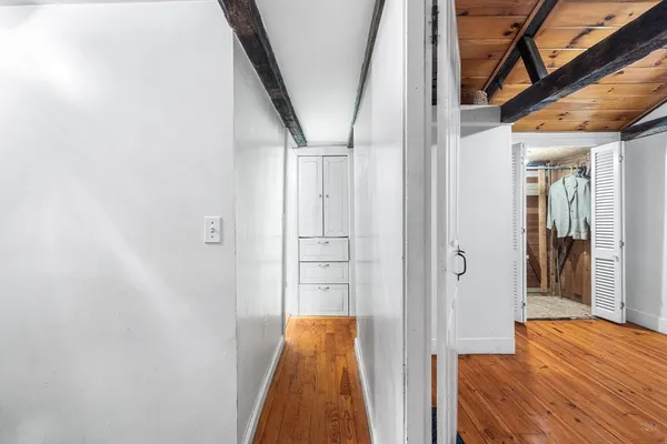 a view of a room with wooden floor and windows