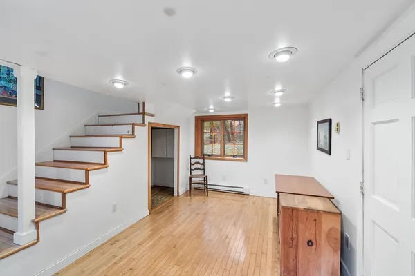a view of an empty room with stairs and ventilation