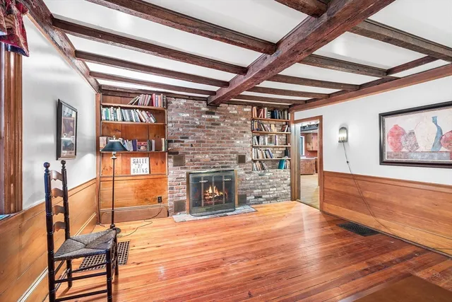 a view of a room with wooden floor and iron stairs
