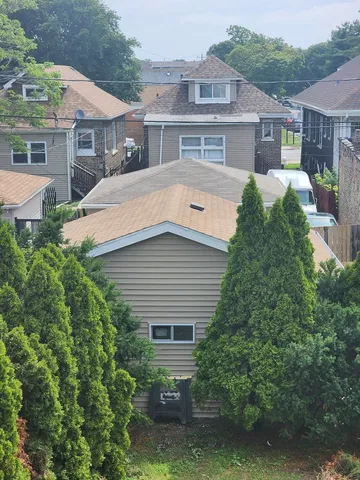 a front view of a house with a yard and potted plants