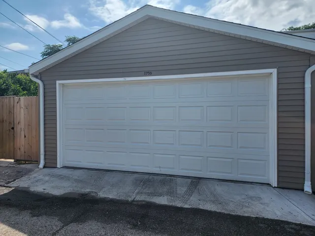 a side view of a house with a garage