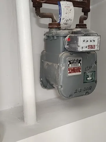 a view of water heater room with a stove