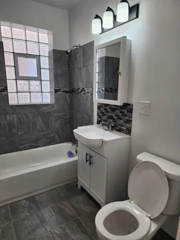 a bathroom with a sink a toilet and bathtub