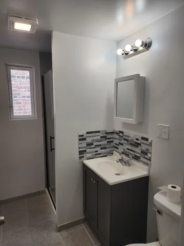 a bathroom with a sink vanity and a mirror