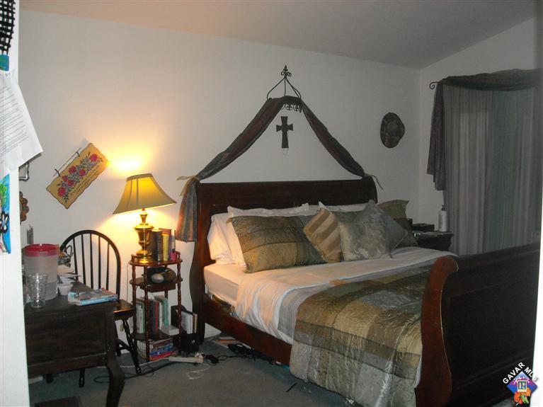 3125 Shale Road Palmdale, CA 93550 - Photo 5 of 8 a bedroom with a bed a lamp and wooden floor