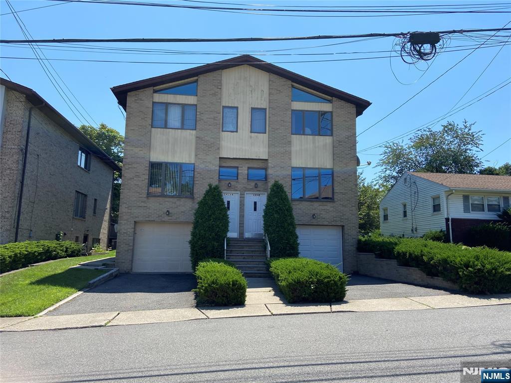 2416 Hammett Avenue, Unit A Fort Lee, NJ 07024 - Photo 1 of 8 a front view of house with garage and yard