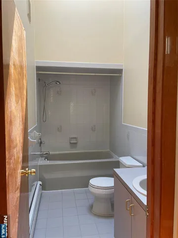 a bathroom with a toilet a sink and shower