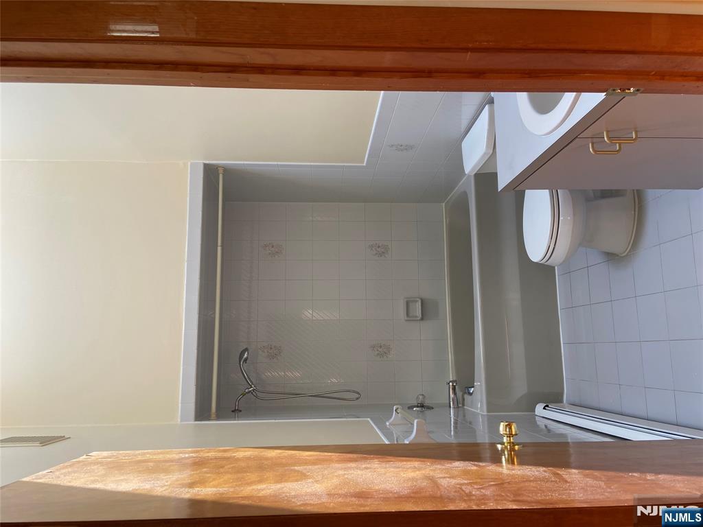 2416 Hammett Avenue, Unit A Fort Lee, NJ 07024 - Photo 6 of 8 a bathroom with a toilet a sink and shower