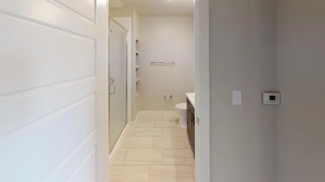 a view of a bathroom from a hallway