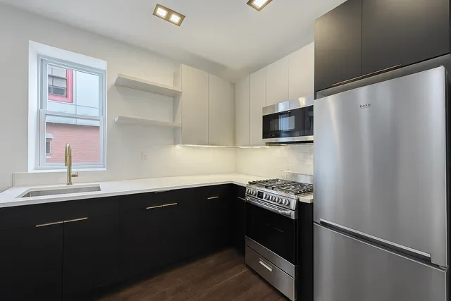 a kitchen with a sink and a refrigerator