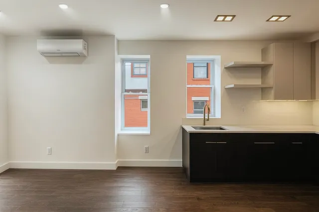 a room with wooden floor and window