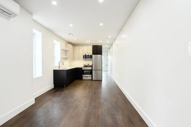 a view of kitchen with wooden floor