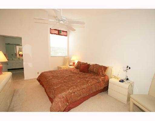 5359 Buckhead Circle Boca Raton, FL 33431 - Photo 7 of 8 a bedroom with a bed and a lamp