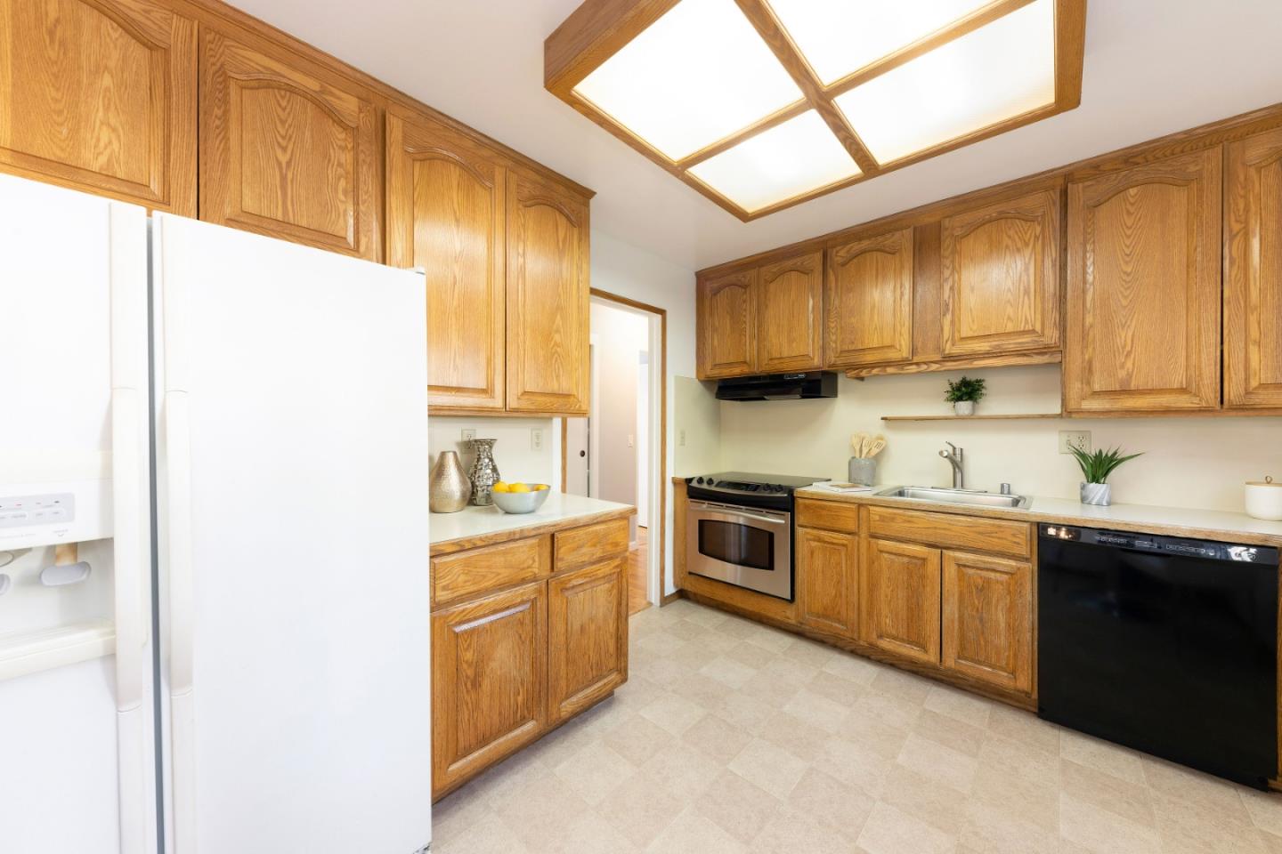1168 Crespi Drive Pacifica, CA 94044 - Photo 11 of 42 a kitchen with stainless steel appliances granite countertop a sink a stove and a refrigerator