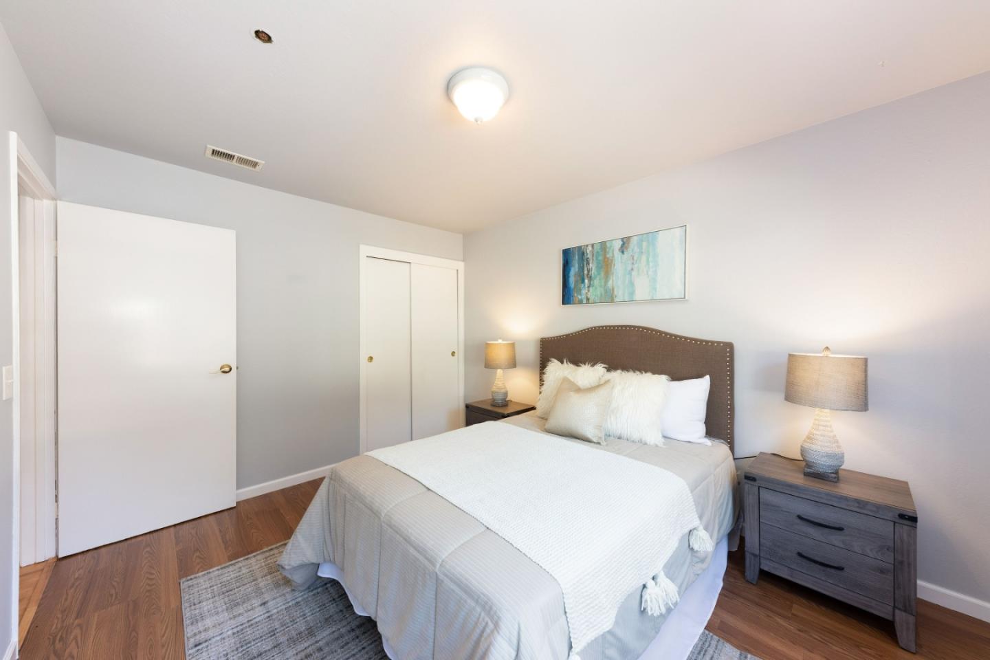 1168 Crespi Drive Pacifica, CA 94044 - Photo 19 of 42 a bedroom with a bed and wooden floor