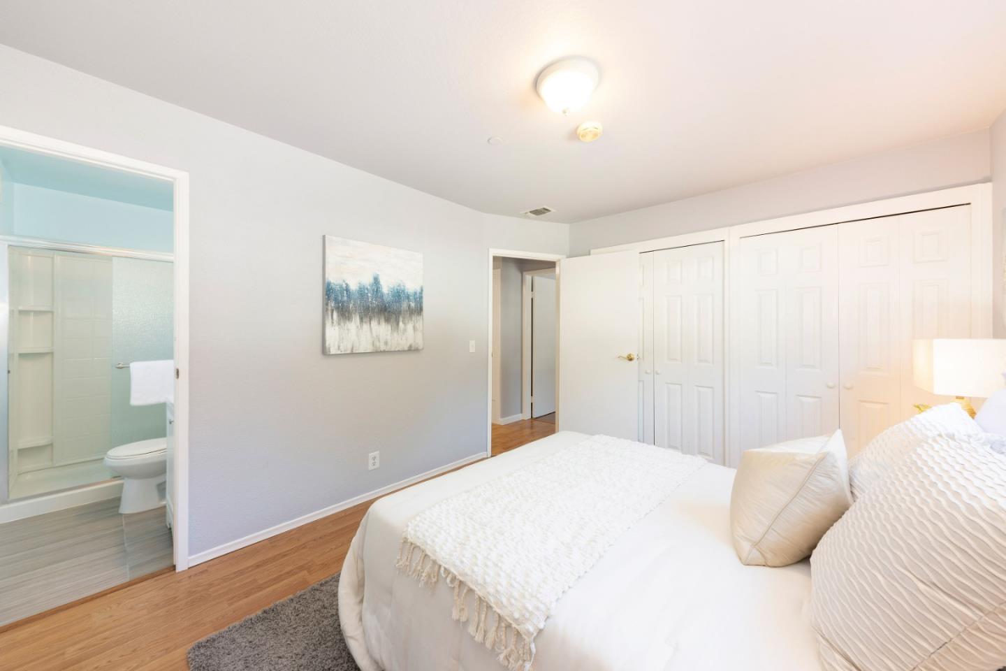 1168 Crespi Drive Pacifica, CA 94044 - Photo 22 of 42 a bedroom with a large bed and a chandelier