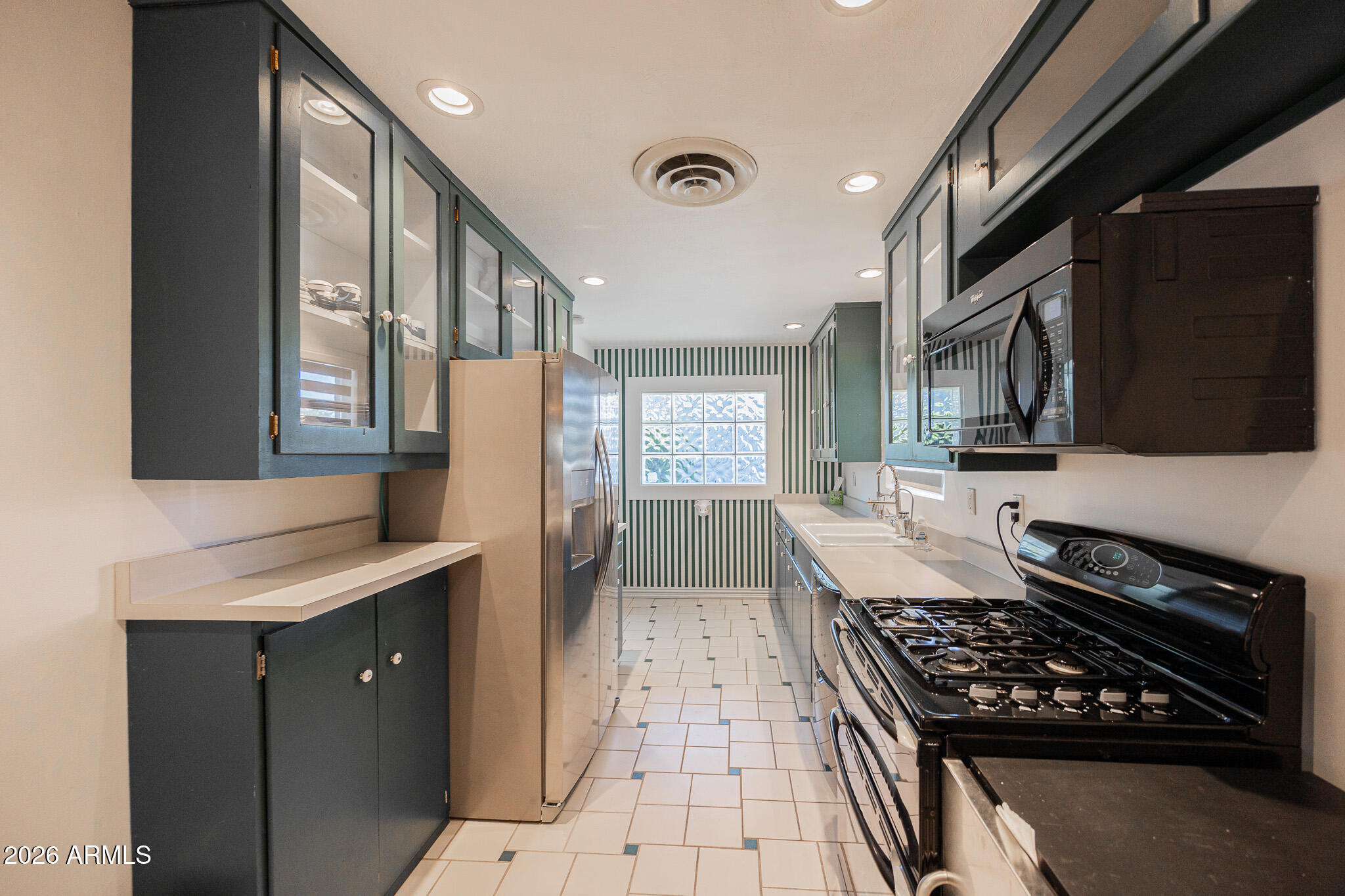 3137 North 4th Avenue Phoenix, AZ 85013 - Photo 12 of 36 a kitchen with stainless steel appliances granite countertop a stove a sink dishwasher and a refrigerator