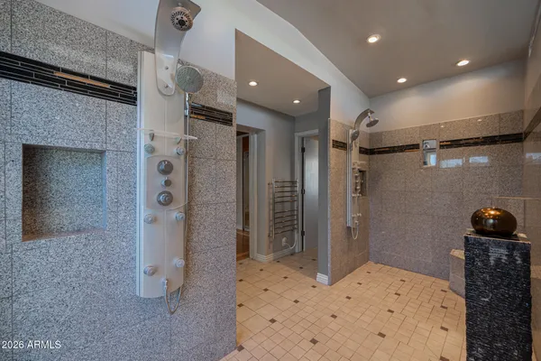 a bathroom with a glass door shower and a sink