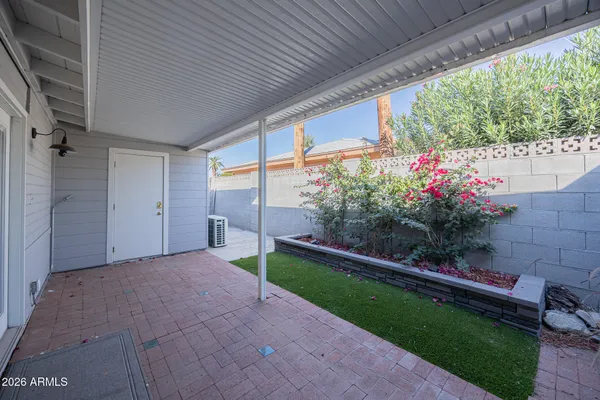 a view of a house with a porch and garden