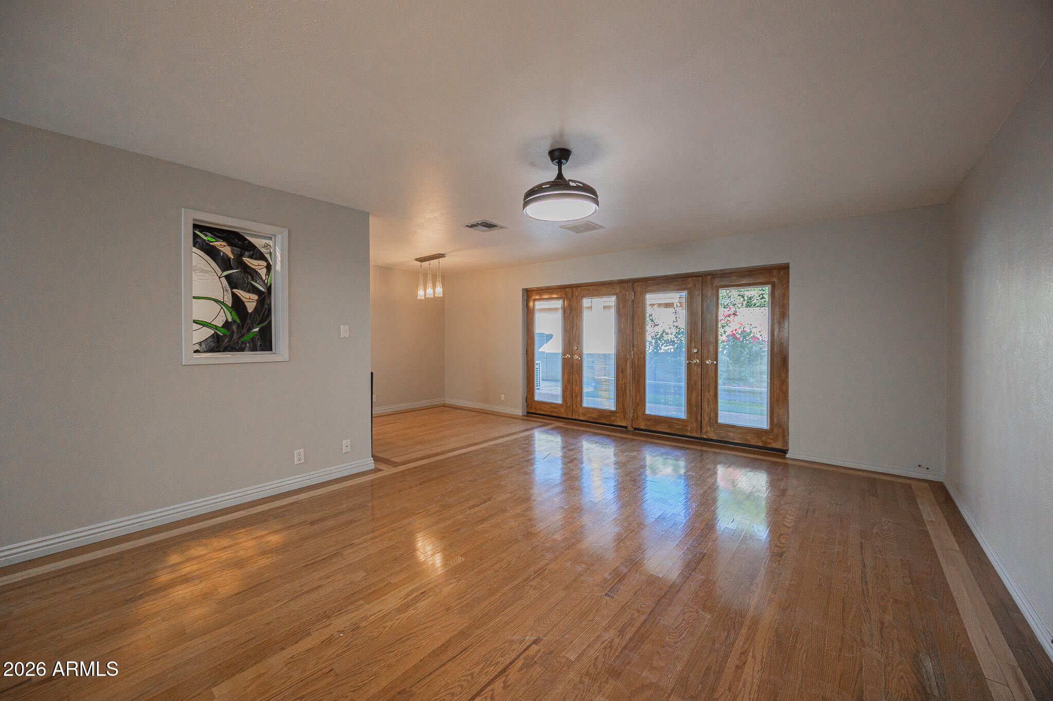 3137 North 4th Avenue Phoenix, AZ 85013 - Photo 6 of 36 a view of an empty room with wooden floor and a window