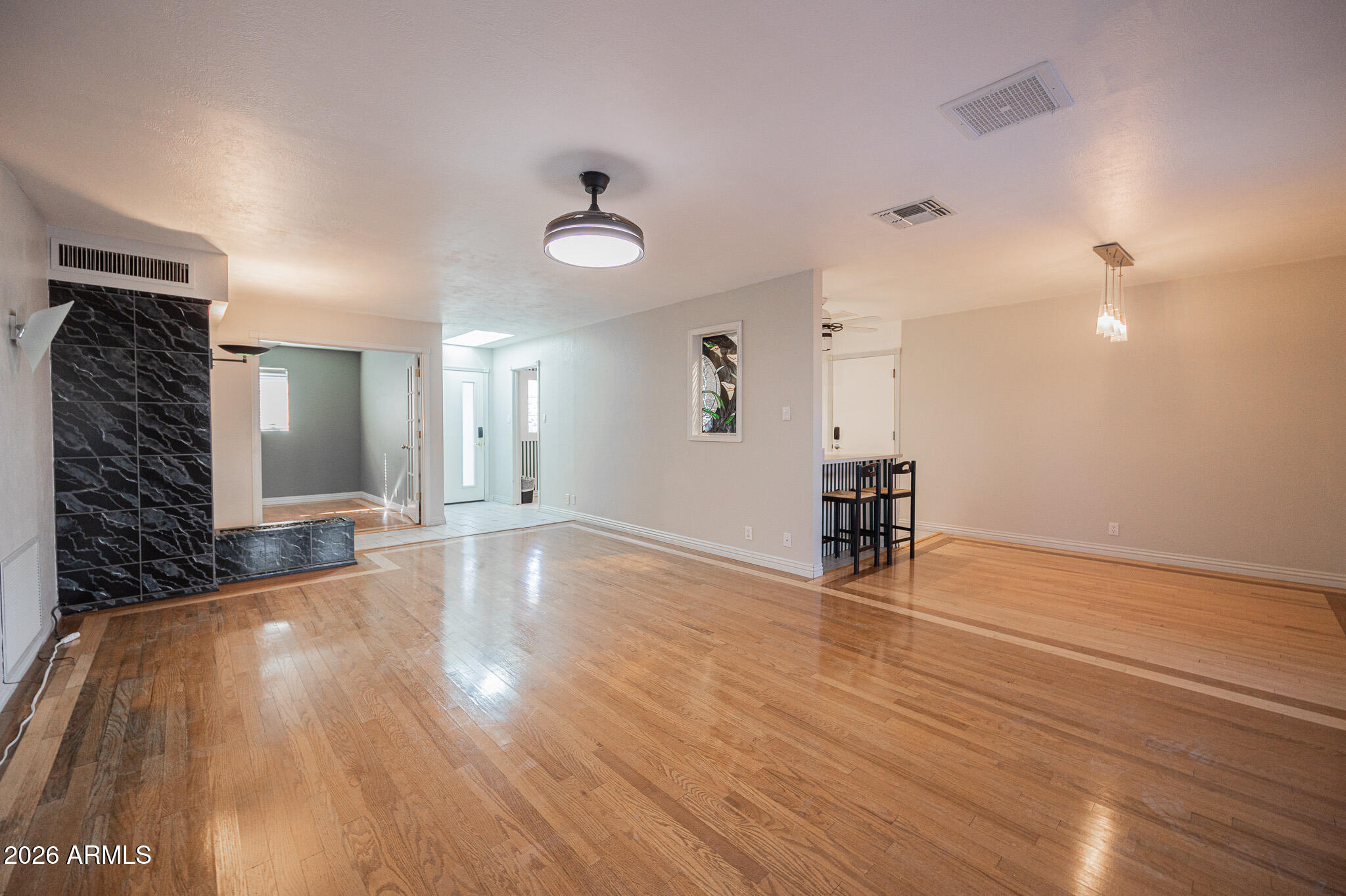 3137 North 4th Avenue Phoenix, AZ 85013 - Photo 7 of 36 a view of empty room with wooden floor and fan