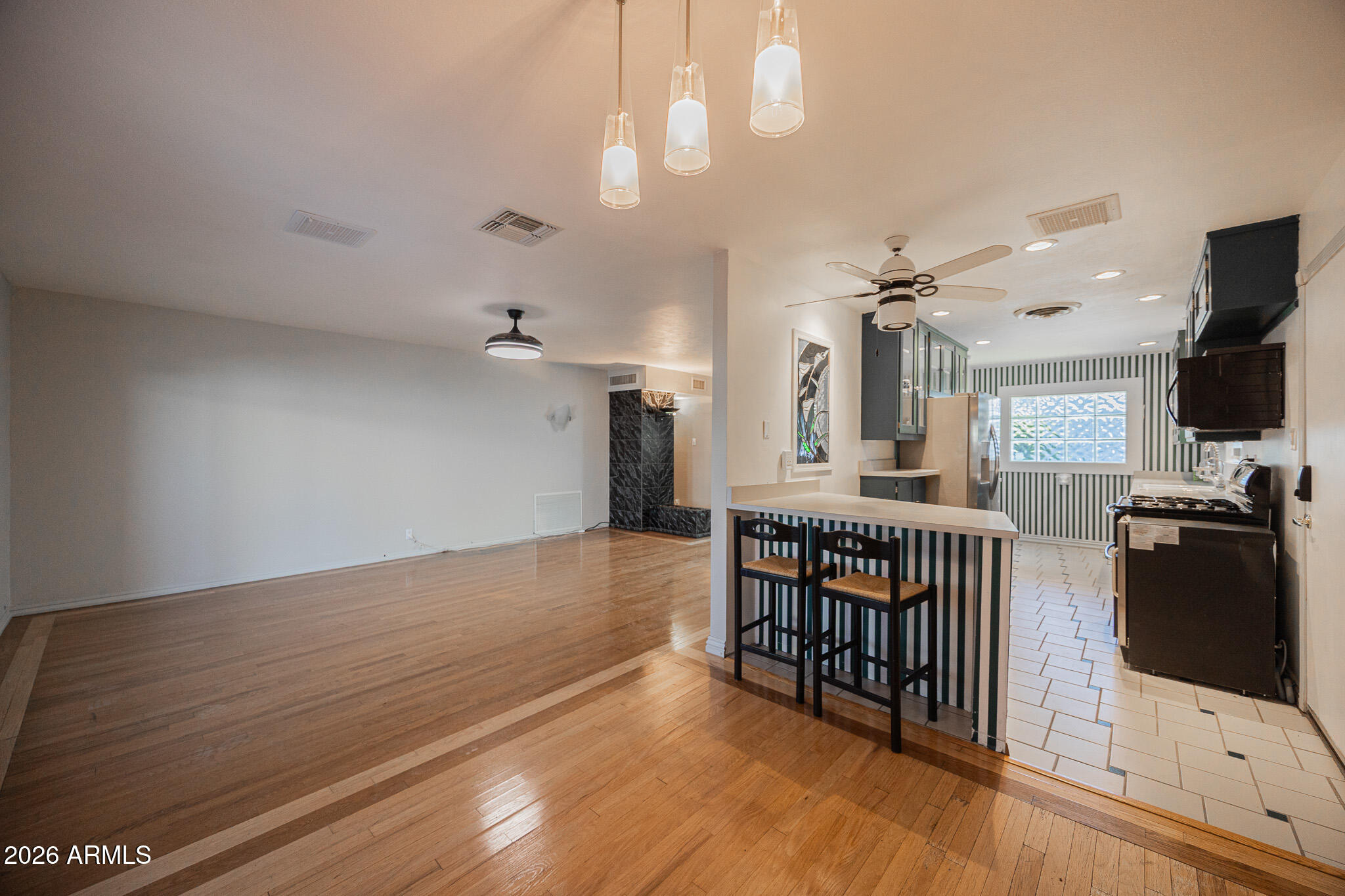 3137 North 4th Avenue Phoenix, AZ 85013 - Photo 9 of 36 a view of a livingroom with a furniture hardwood floor and a ceiling fan