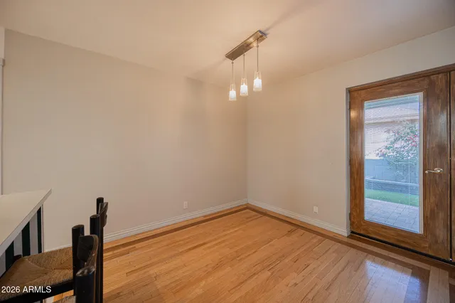 a view of a room with wooden floor and windows