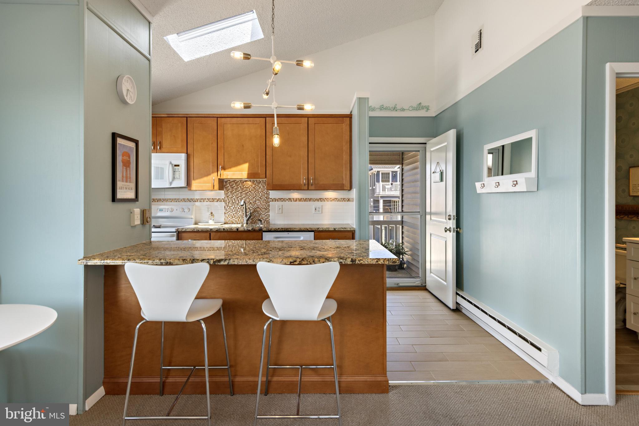 24 Joan Road Long Beach Township, NJ 08008 - Photo 13 of 55 a large kitchen with a table and chairs