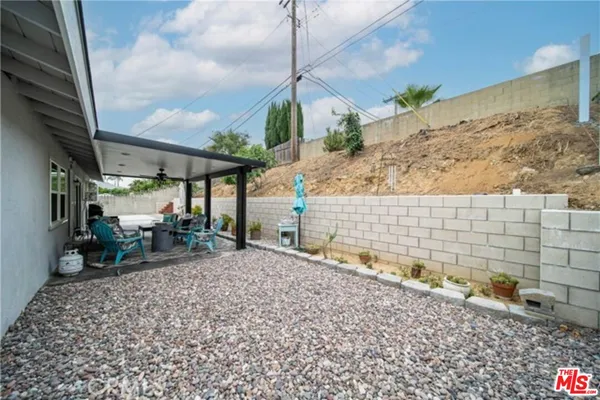 a view of a backyard with plants and a lake view