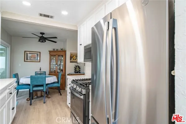 a kitchen with a sink cabinets and wooden floor