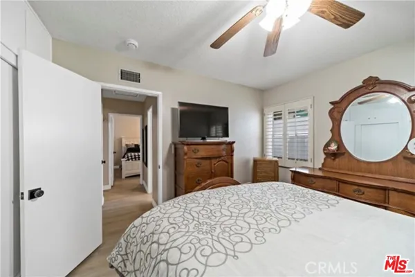 a bedroom with a bed and window with lamp