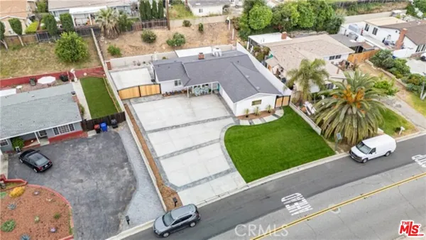 an aerial view of a house with a yard
