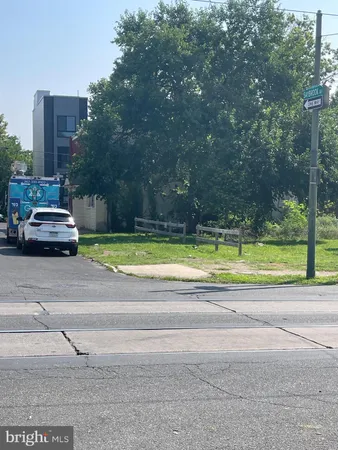 a view of a cars park on the side of a street