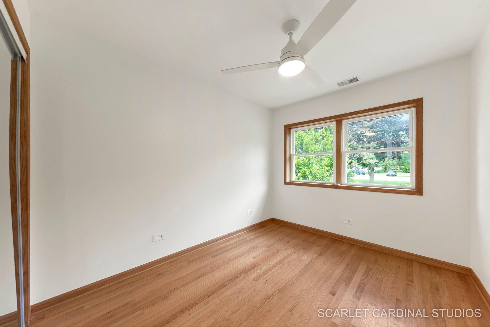 706 South Gables Boulevard Wheaton, IL 60189 - Photo 17 of 26 an empty room with wooden floor and windows