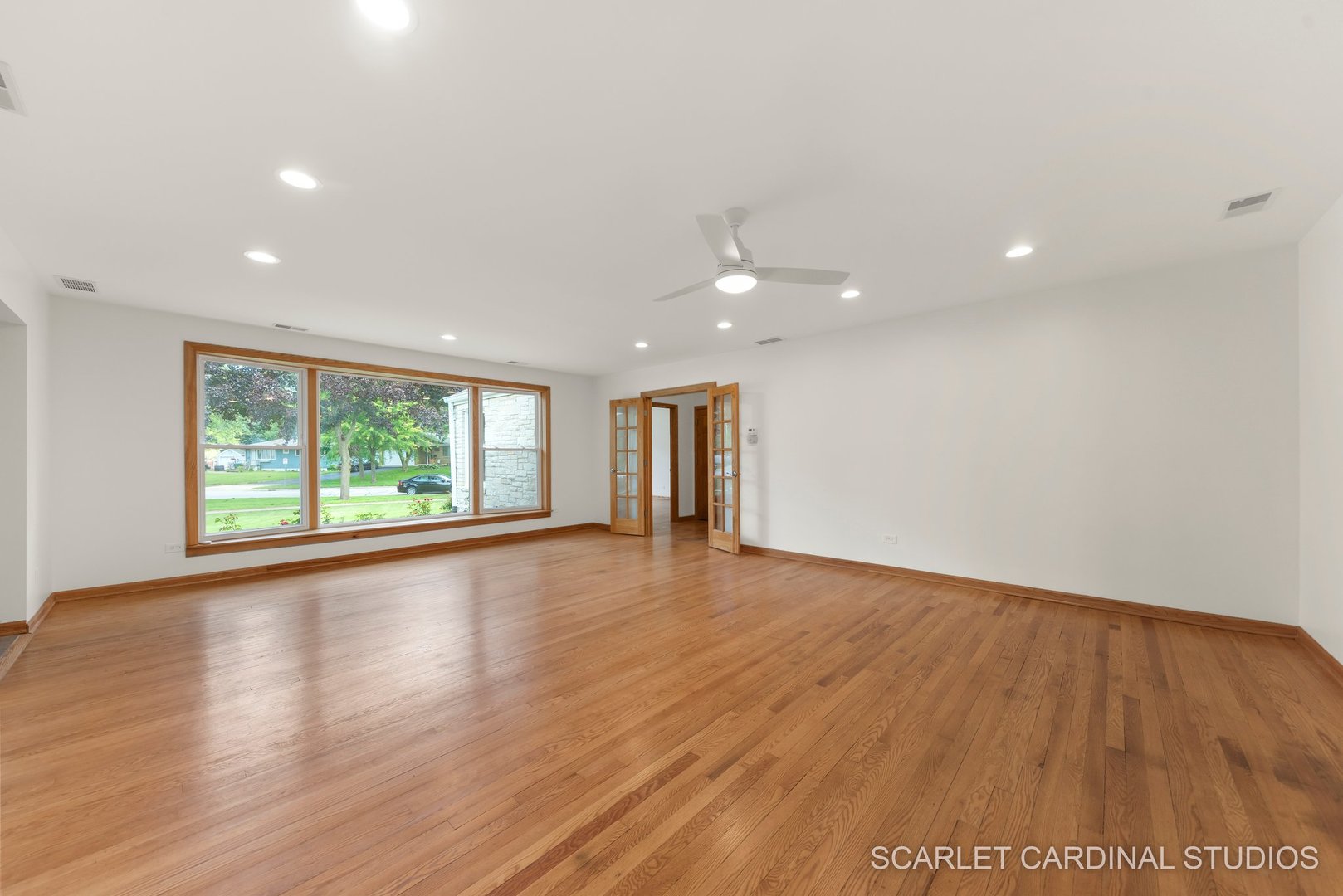 706 South Gables Boulevard Wheaton, IL 60189 - Photo 5 of 26 a view of an empty room with wooden floor and a window