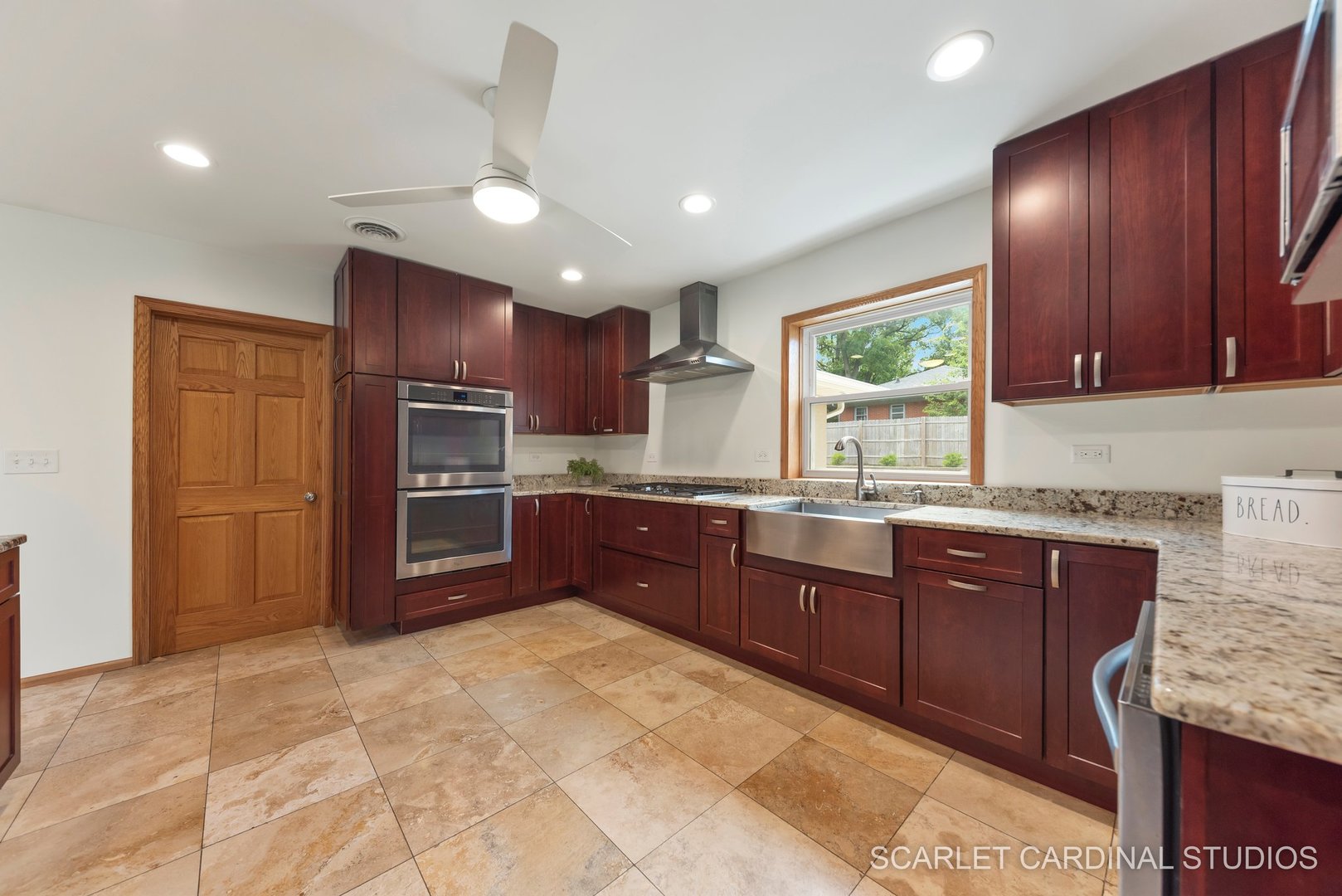 706 South Gables Boulevard Wheaton, IL 60189 - Photo 7 of 26 a kitchen with stainless steel appliances granite countertop a stove refrigerator and cabinets