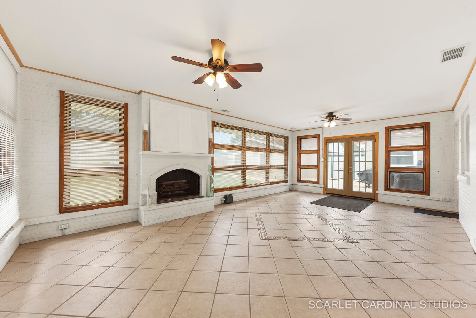 706 South Gables Boulevard Wheaton, IL 60189 - Photo 10 of 26 a view of an empty room with a fireplace and a window