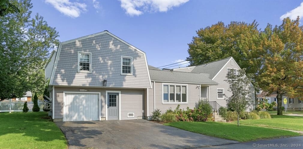 550 Reef Road Fairfield, CT 06824 - Photo 1 of 1 a front view of a house with a garden