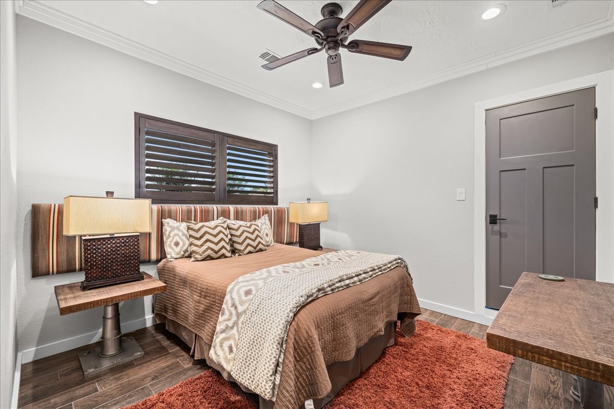 1502 Reimer Street Brenham, TX 77833 - Photo 21 of 30 a bedroom with a bed a couch and a window