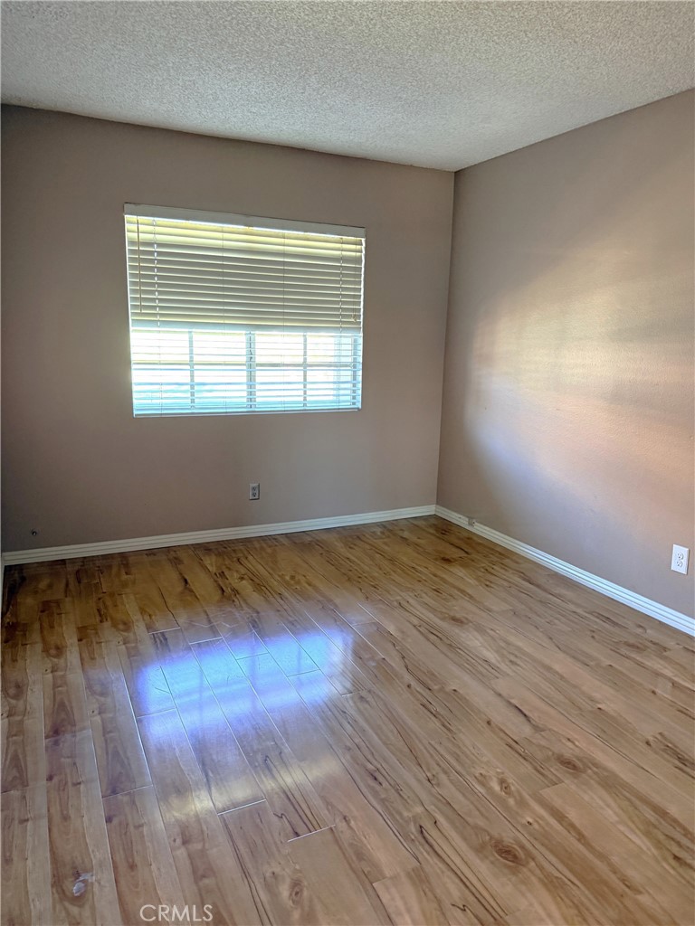 8939 Gallatin Road, Unit 123 Pico Rivera, CA 90660 - Photo 18 of 21 a view of empty room with wooden floor and fan