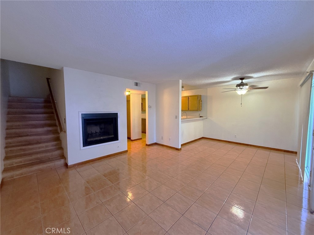 8939 Gallatin Road, Unit 123 Pico Rivera, CA 90660 - Photo 6 of 21 wooden floor fireplace and windows in an empty room