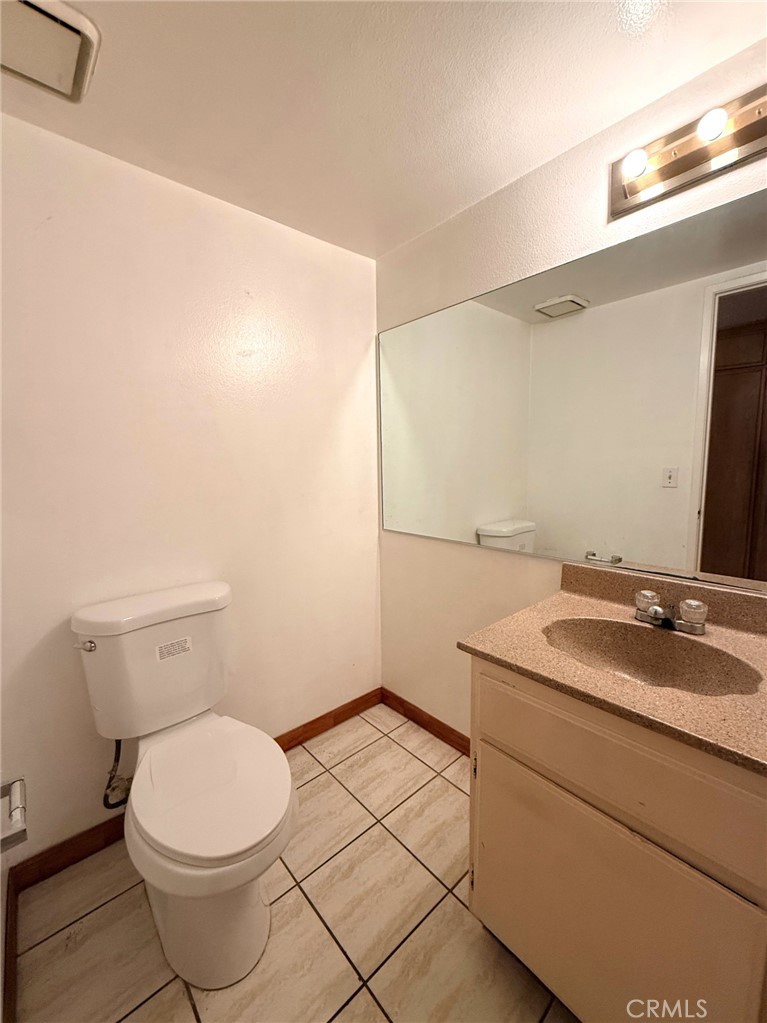 8939 Gallatin Road, Unit 123 Pico Rivera, CA 90660 - Photo 10 of 21 a bathroom with a granite countertop sink and a mirror
