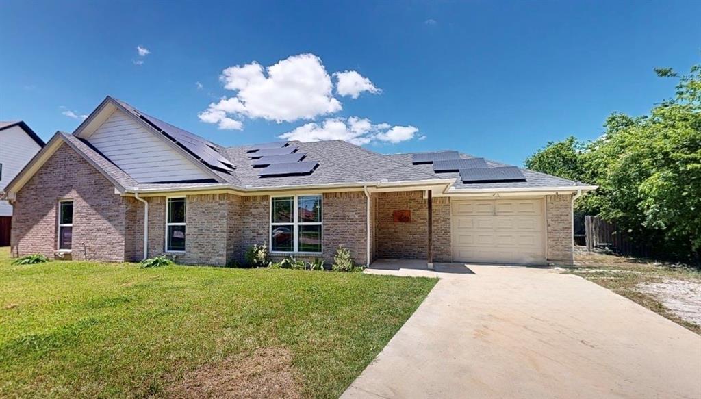 Brick exterior with a gabled roofline and multiple solar panels