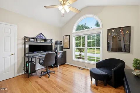 a view of a workspace with furniture and a window