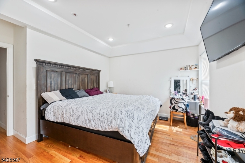 14 Spencer Street Elizabeth, NJ 07202 - Photo 11 of 39 a bedroom with a bed and wooden floor