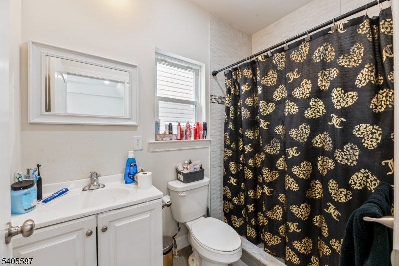 14 Spencer Street Elizabeth, NJ 07202 - Photo 12 of 39 a white toilet sitting next to a bathroom sink