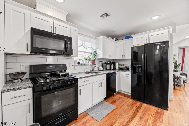 14 Spencer Street Elizabeth, NJ 07202 - Photo 20 of 39 a kitchen with a refrigerator stove and microwave