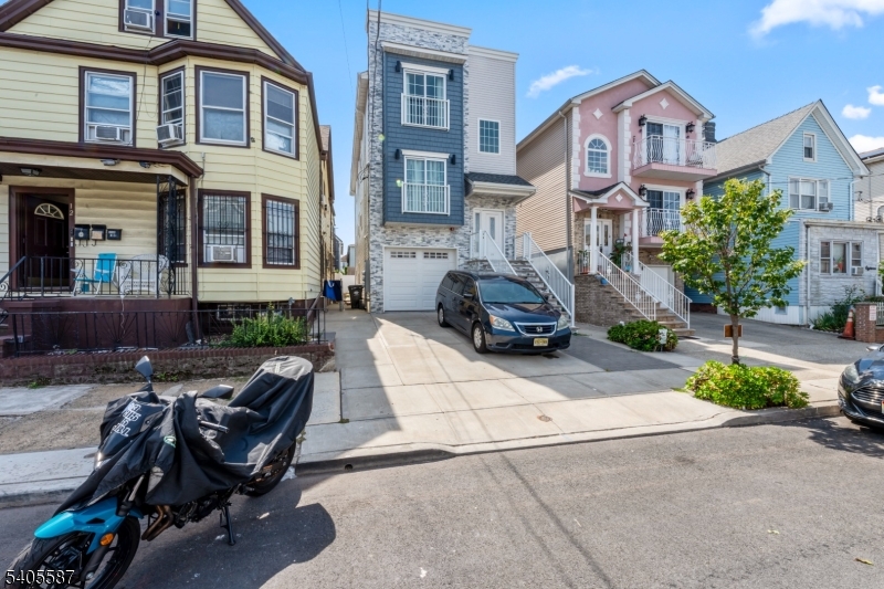 14 Spencer Street Elizabeth, NJ 07202 - Photo 2 of 39 a view of a brick building with a bench and a car parked in front of it