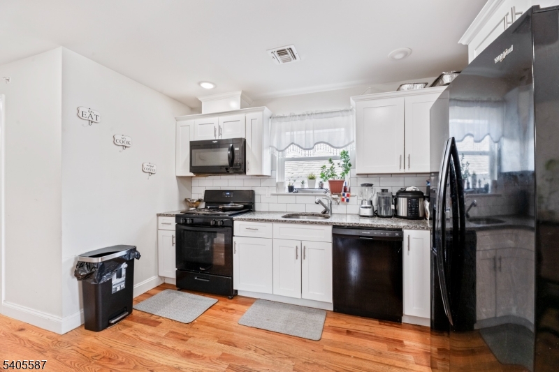 14 Spencer Street Elizabeth, NJ 07202 - Photo 21 of 39 a kitchen with a refrigerator stove and sink