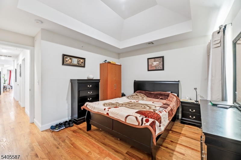 14 Spencer Street Elizabeth, NJ 07202 - Photo 23 of 39 a bed sitting in a bedroom next to a window
